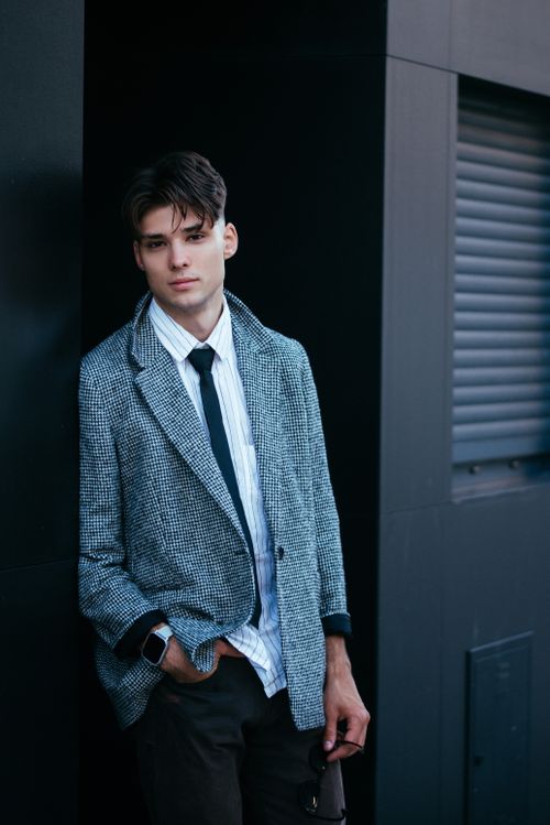 Free Portrait of a well-dressed young man in a modern city environment. Stock Photo