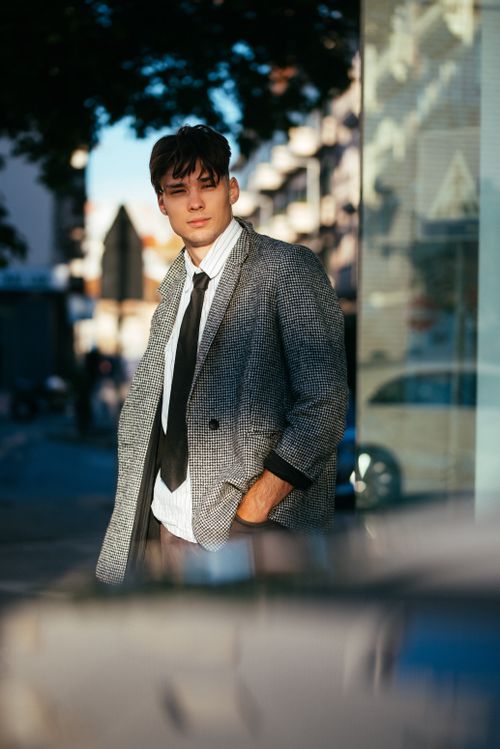 Free Portrait of a young man in smart casual attire on a city street. Stock Photo