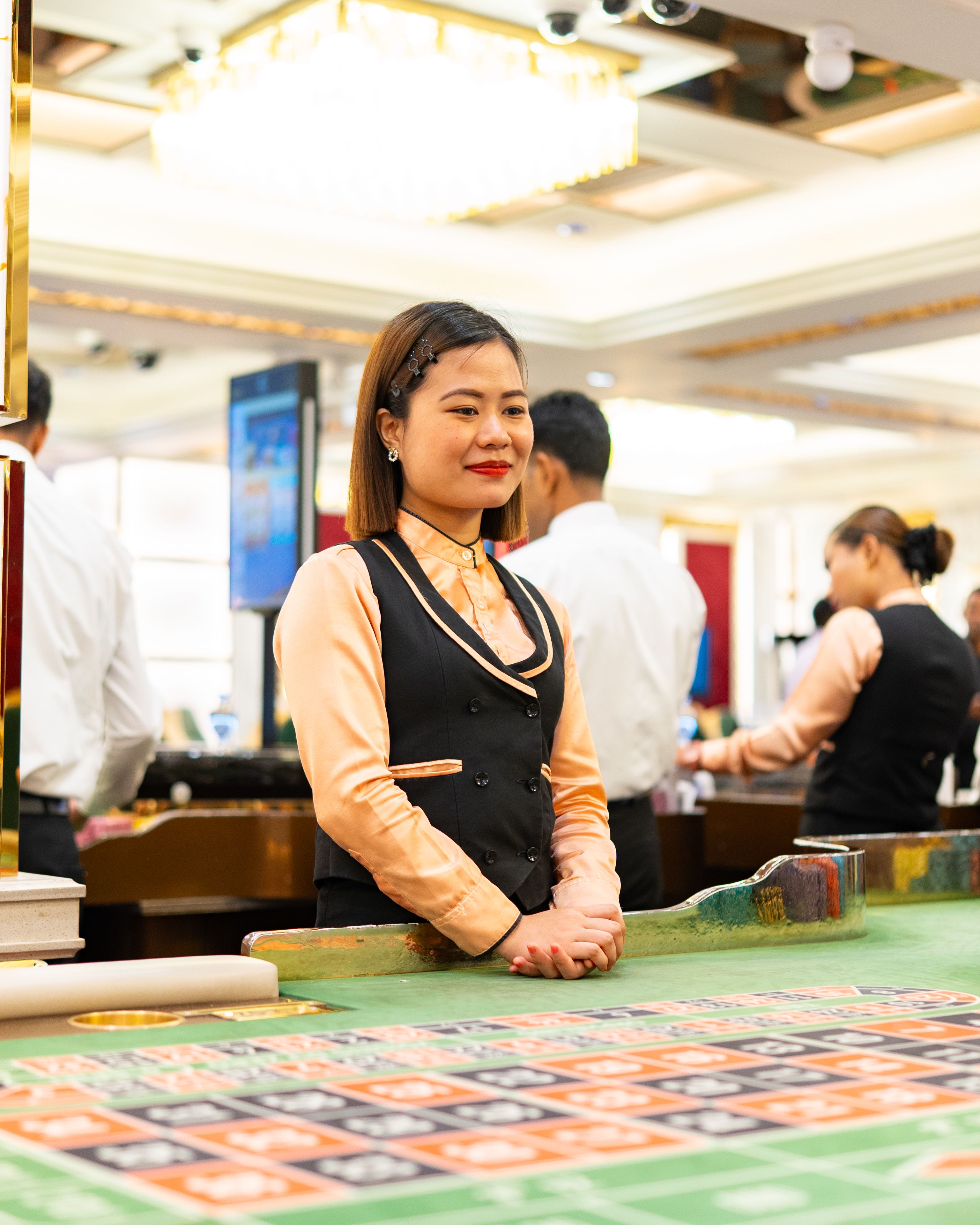 Charming casino dealer in uniform at an upscale casino in Goa.