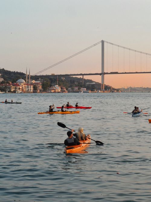 Free Kayakers enjoying sunset on the Bosphorus with the iconic bridge and Istanbul skyline in the background. Stock Photo