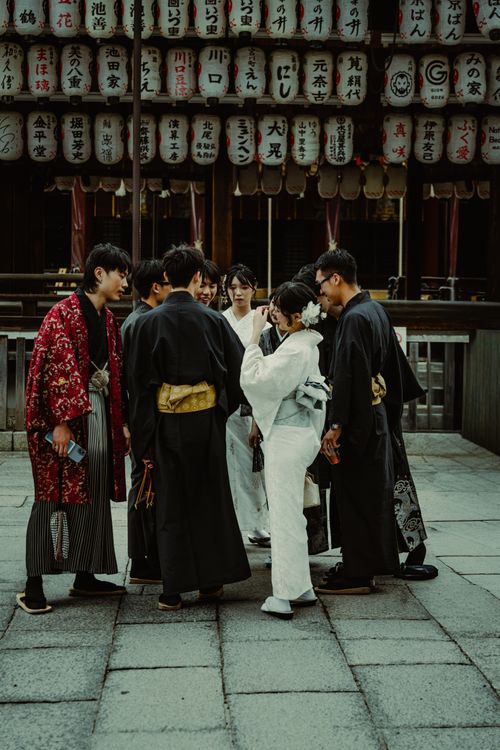 Free Group of people in traditional attire at a Japanese temple with lanterns. Stock Photo