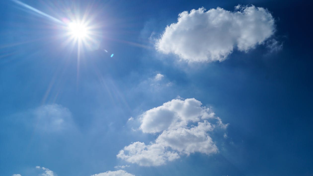 blue sky with sun and white clouds