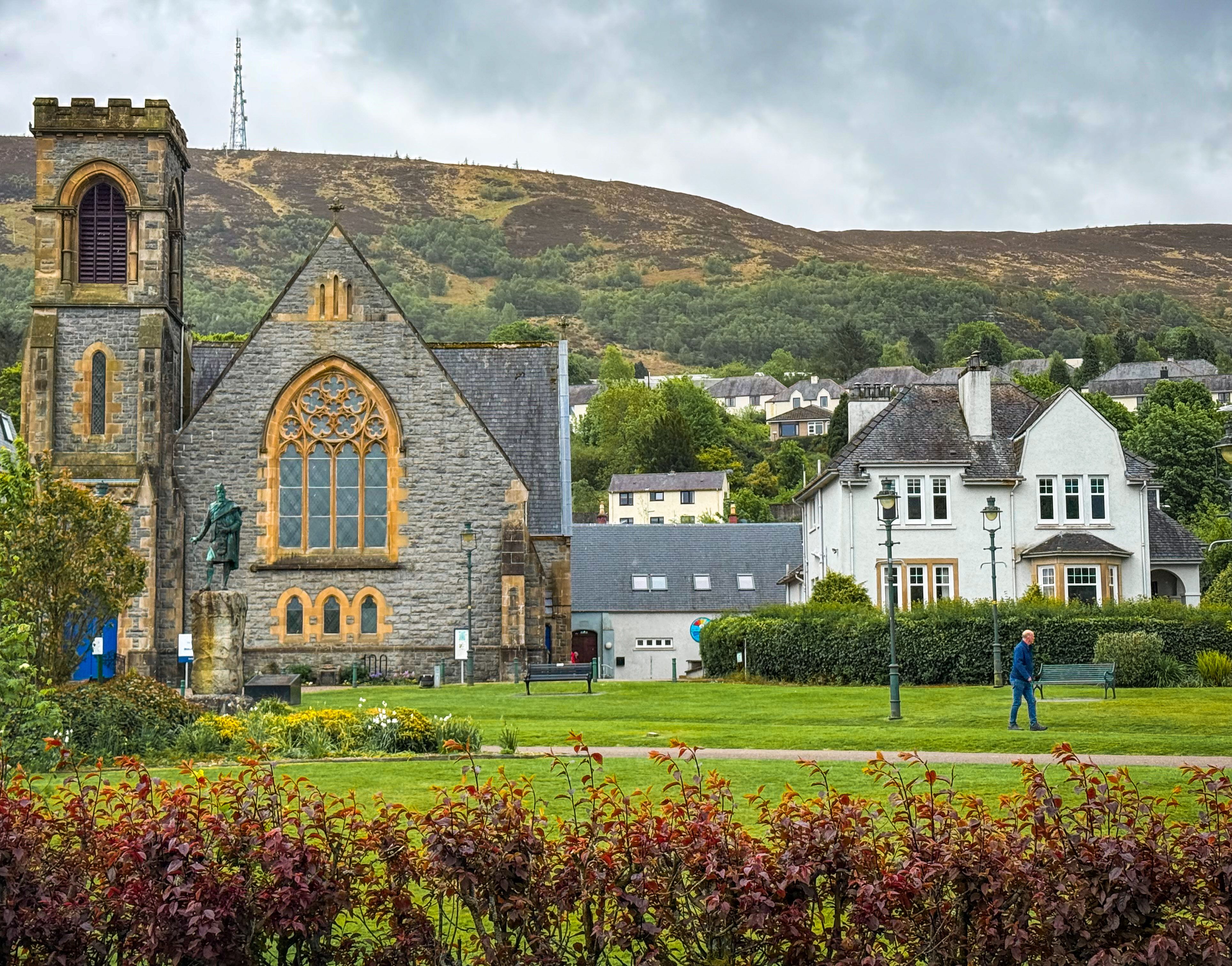 Picturesque scene of a historic church with lush surroundings in Glencoe, Scotland.