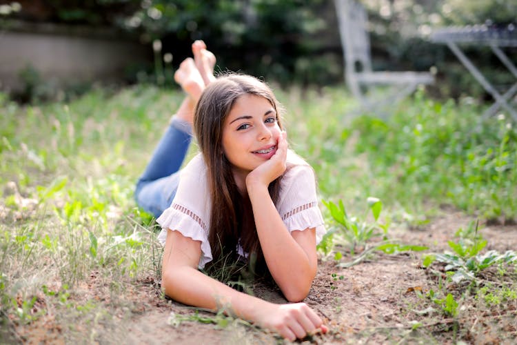 Woman In White Shirt Lying On Ground