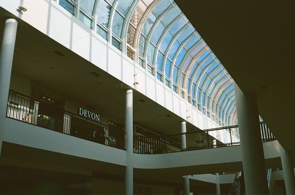 Spacious mall interior in Vancouver showcasing a stunning curved glass skylight.