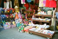A vibrant display of goods outside a Chinatown market, showcasing diverse products.