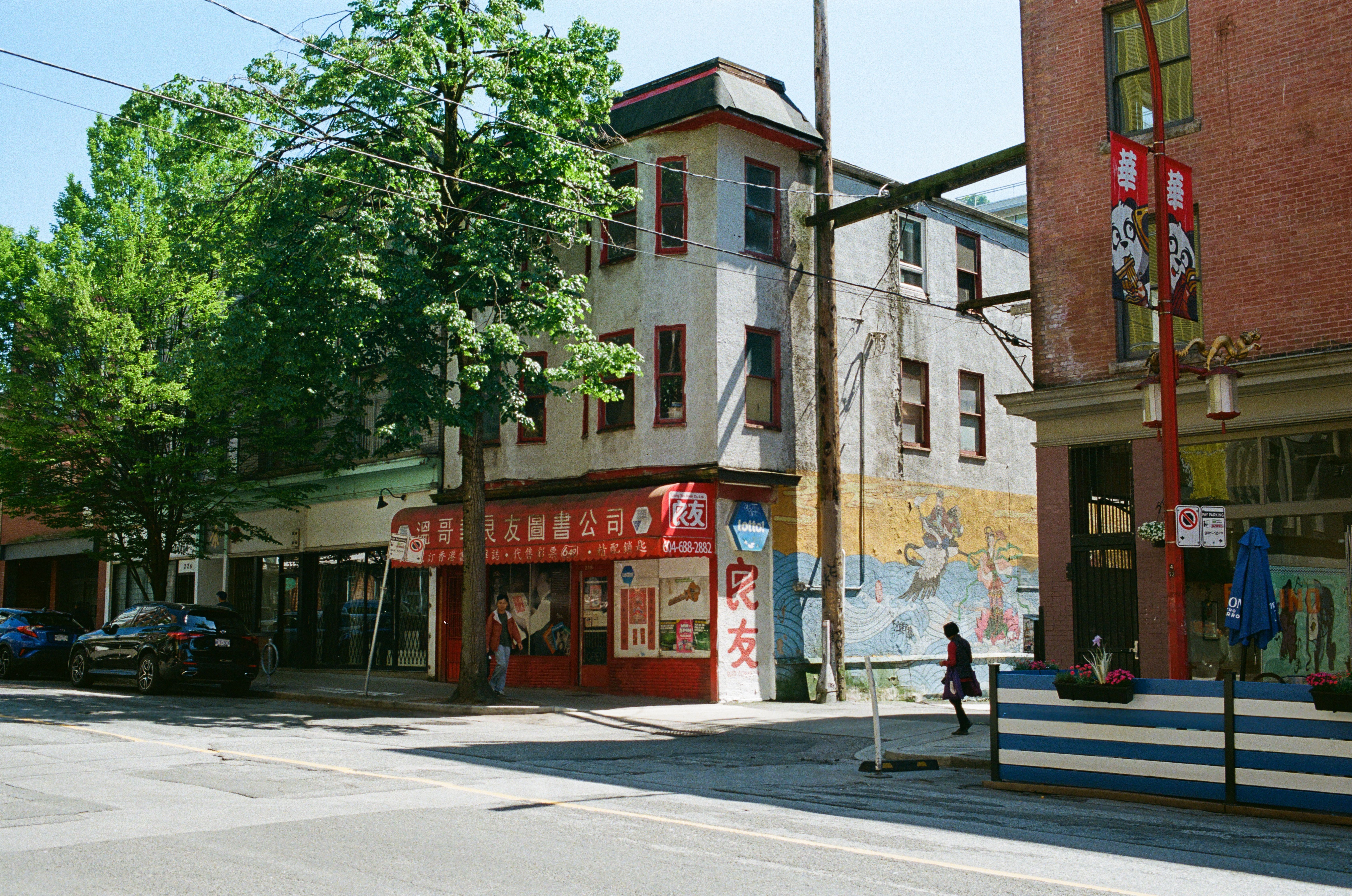 A vibrant street scene in Vancouver's historic Chinatown, showcasing colorful murals and architecture.