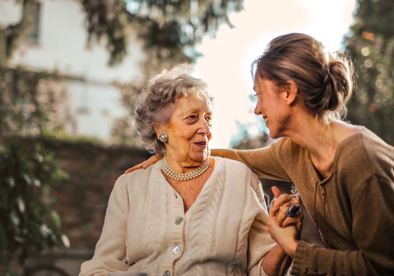 Professional caregiver providing personal care assistance to senior with dementia