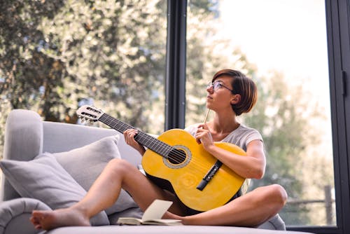 Woman Holding Acoustic Guitar