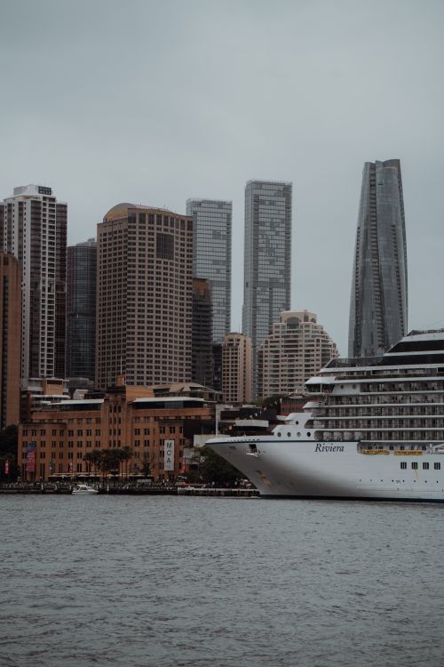 Free View of Sydney's skyline with a cruise ship in the foreground on an overcast day. Stock Photo