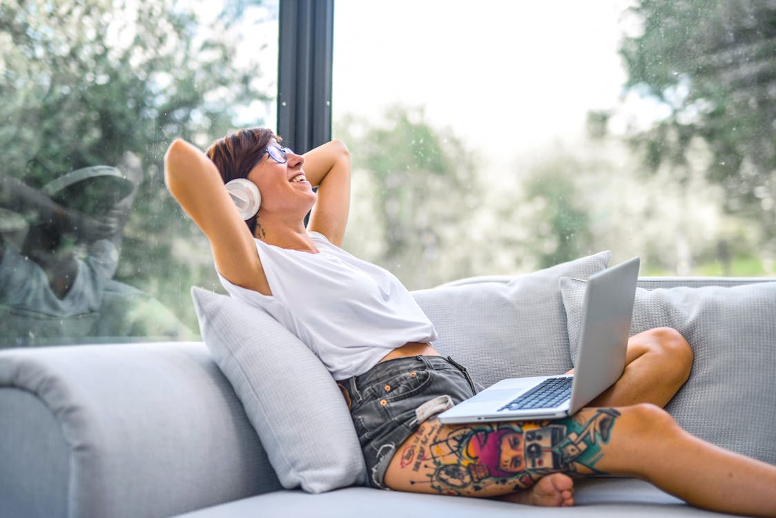 Free Woman Sitting on Couch Stock Photo