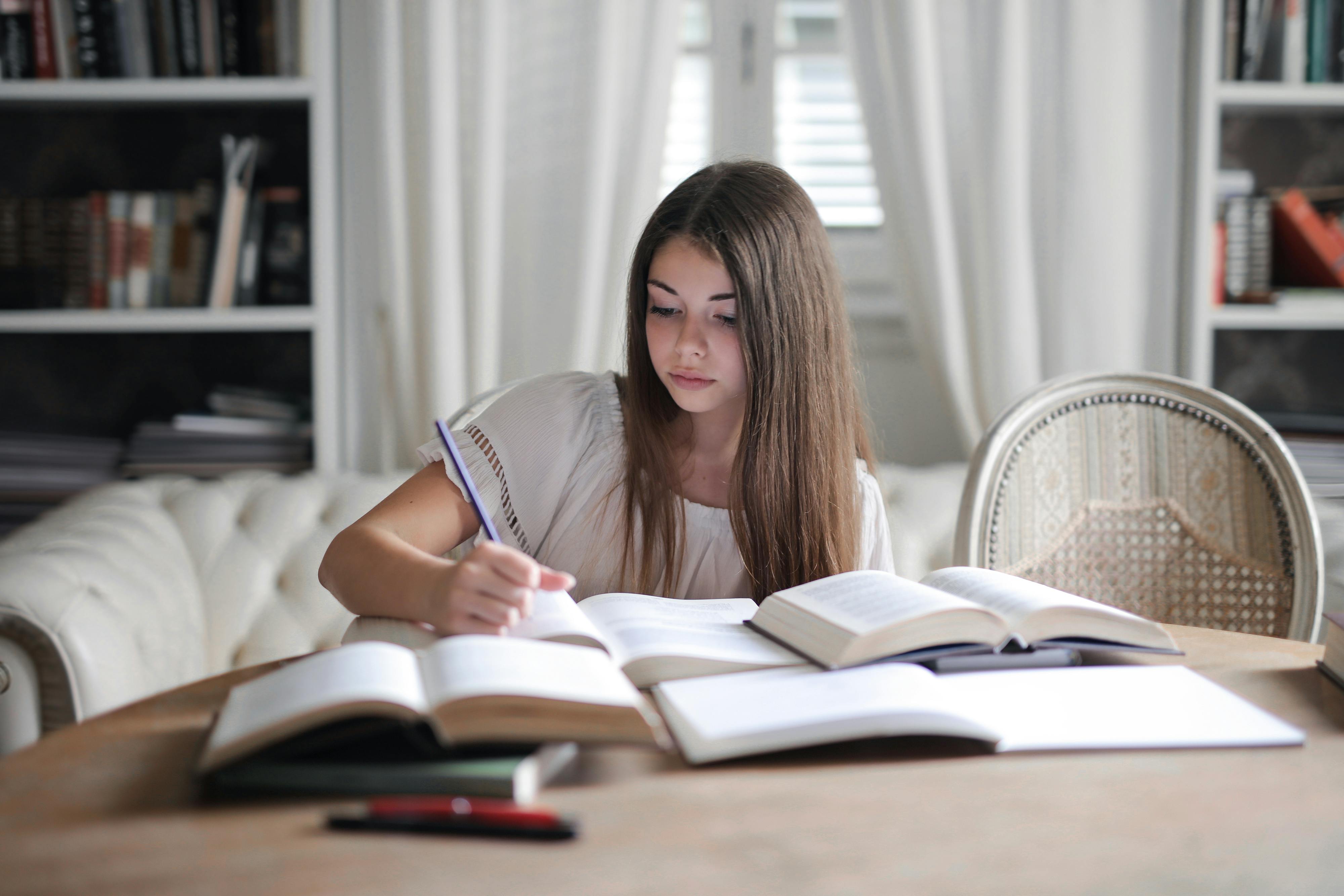 woman in gray long sleeve shirt reading book