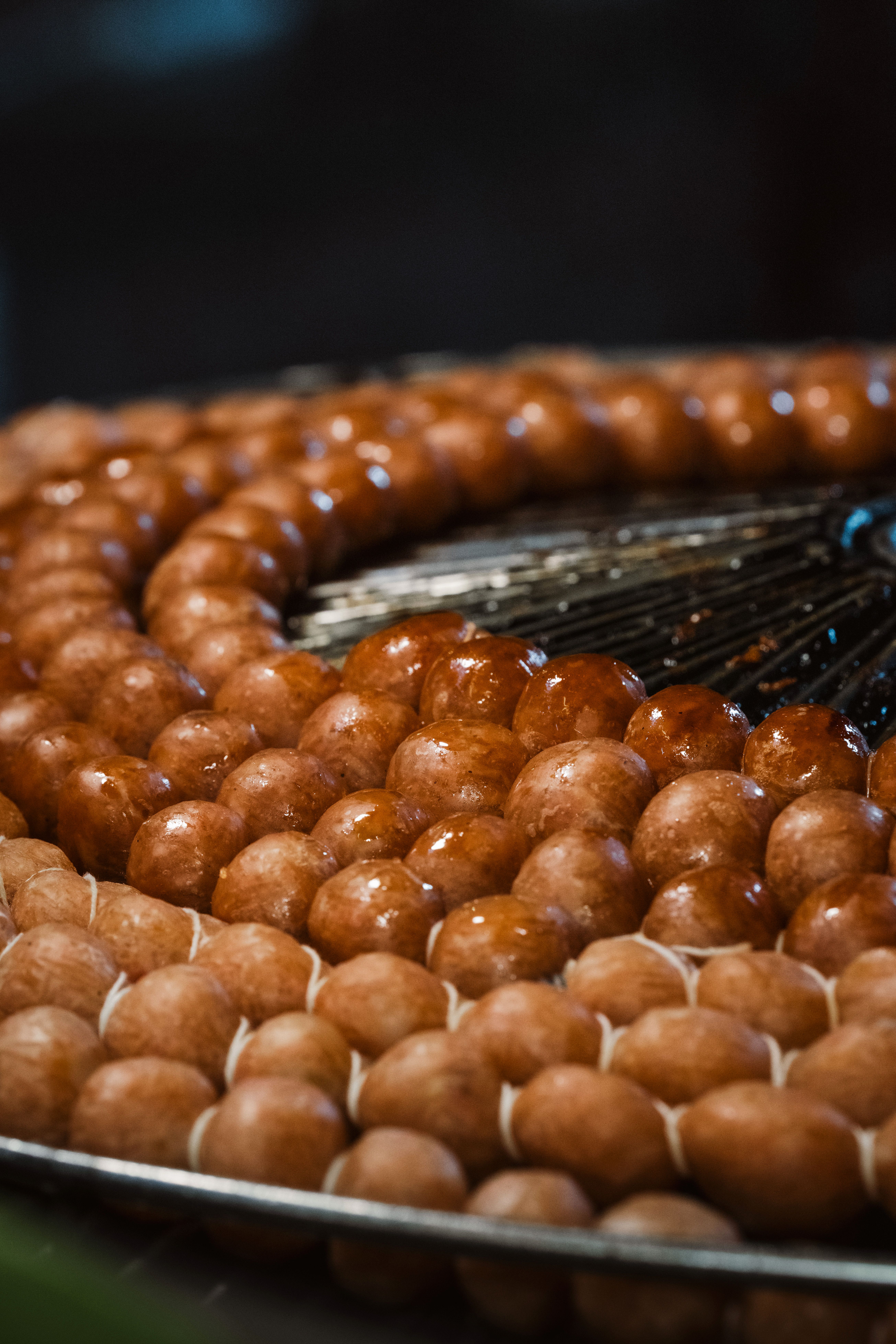 A close-up of glistening sausage skewers, freshly grilled, showcasing culinary street food art.