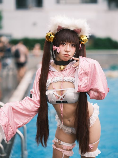 Free Colorful and detailed cosplay portrait featuring a woman in a pink costume by a poolside in Vietnam. Stock Photo