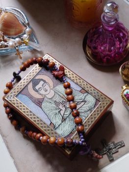 Prayer beads on table with Buddhist temple