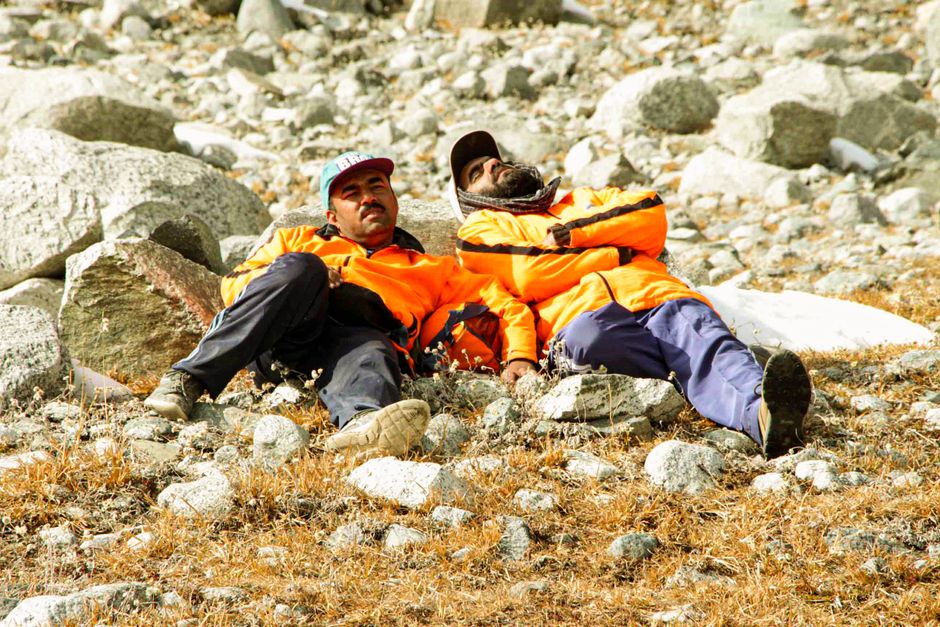 Everest Base Camp Trek - 14 Days - Two trekkers rest on rocky terrain during an expedition in Mankyal, Swat Valley, Pakistan.