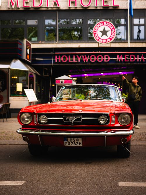 Free A red vintage Mustang parked outside Berlin's iconic Hollywood Media Hotel. Stock Photo