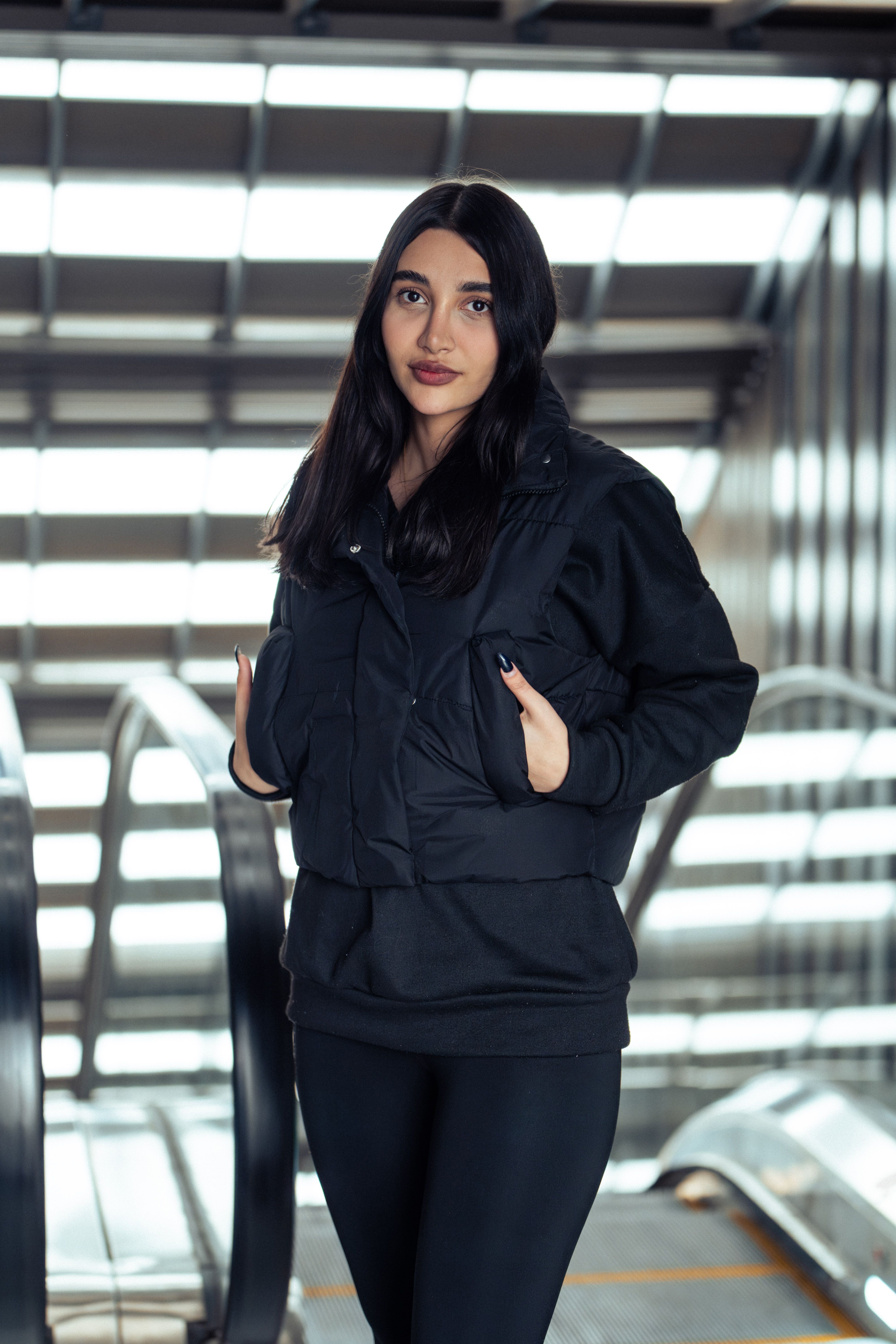 Stylish Woman Posing in Modern Urban Setting · Free Stock Photo