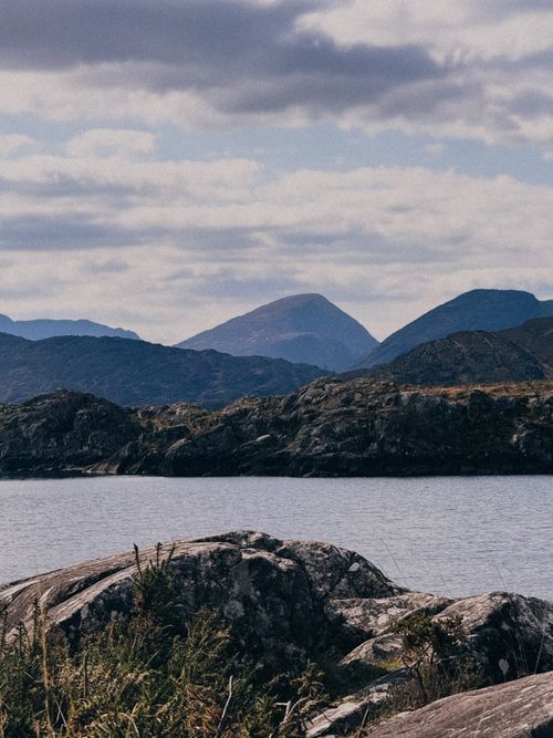 Free Breathtaking view of Irish landscape featuring mountains and a serene lake under a cloudy sky. Stock Photo