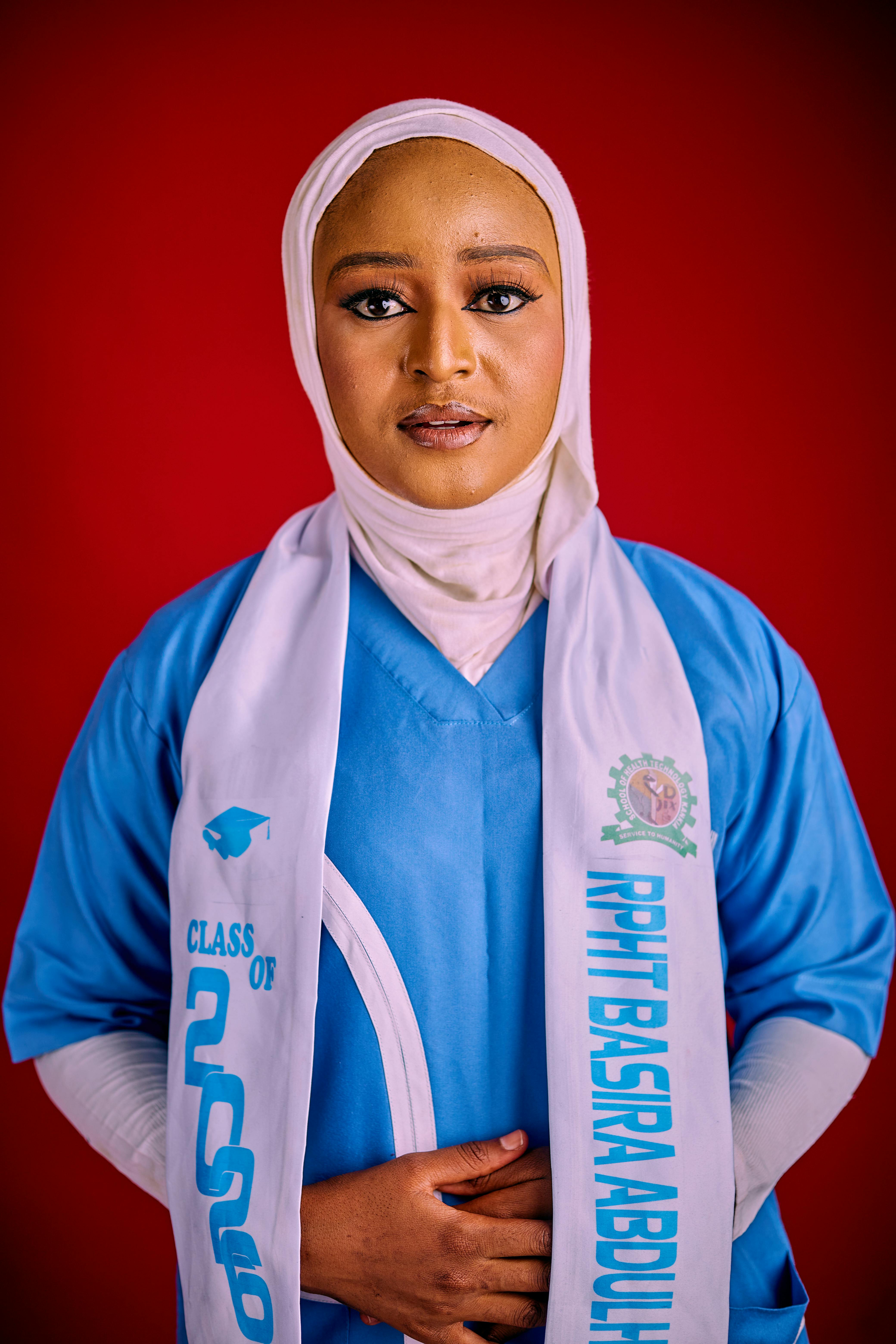 Portrait of a young woman in a graduation gown with hijab, class of 2020.