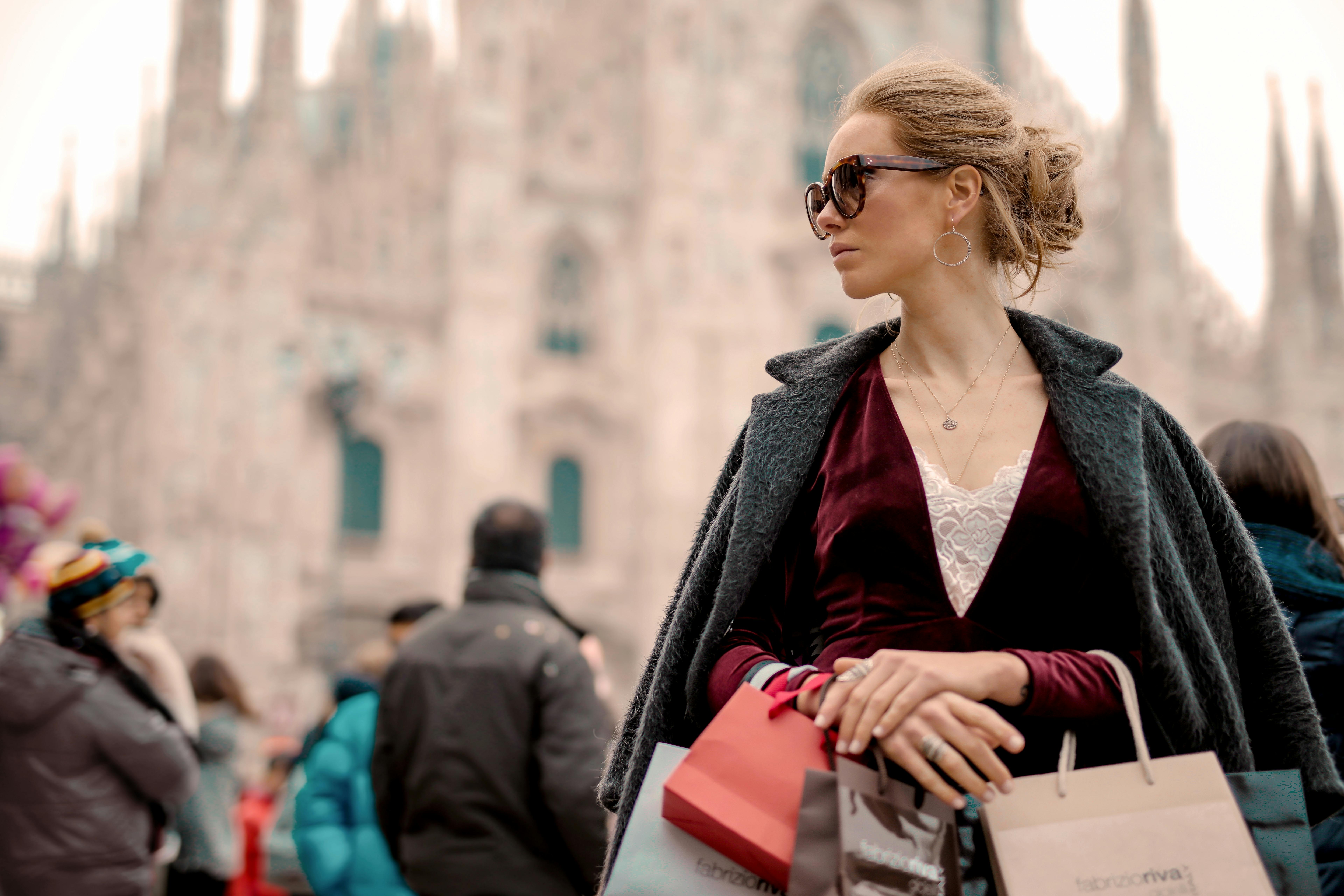 woman in black coat wearing black framed sunglasses