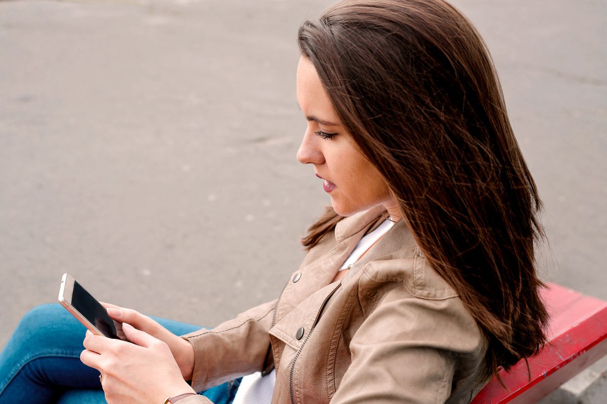 Composing a post on a phone out in the city