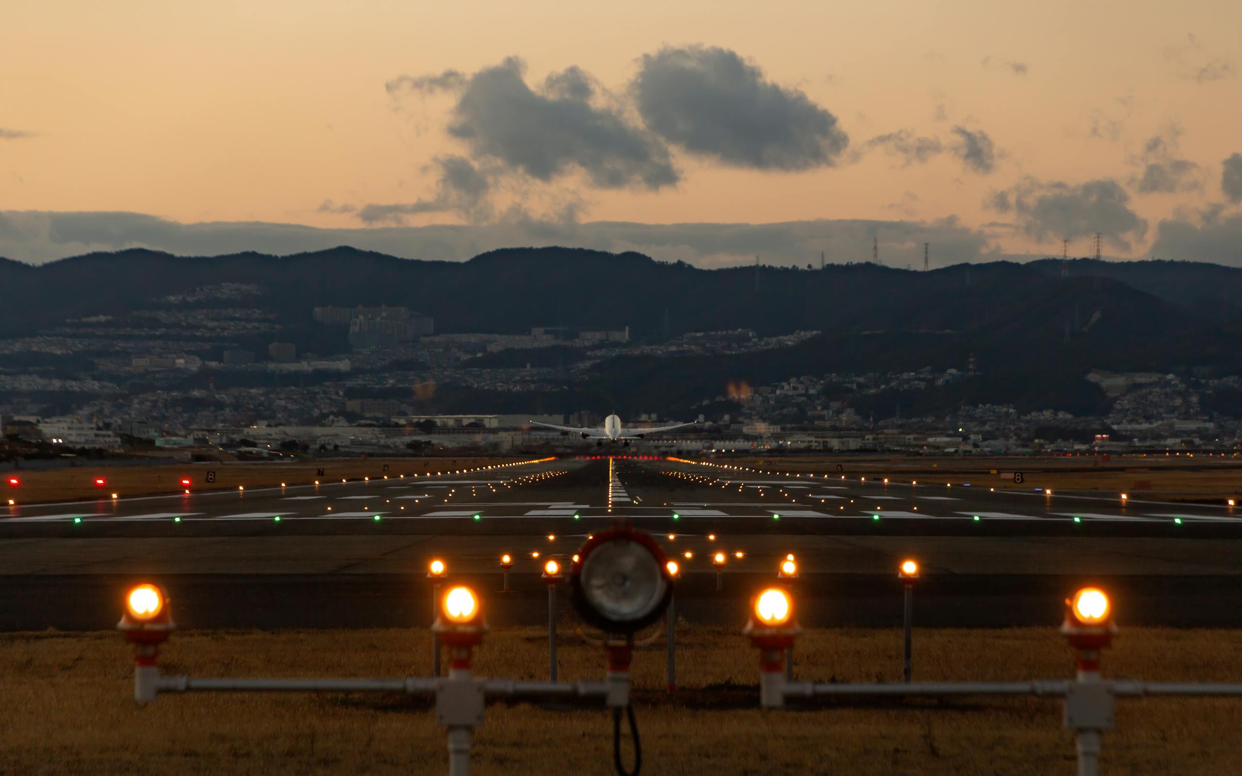 Airplane flying from runway at dusk