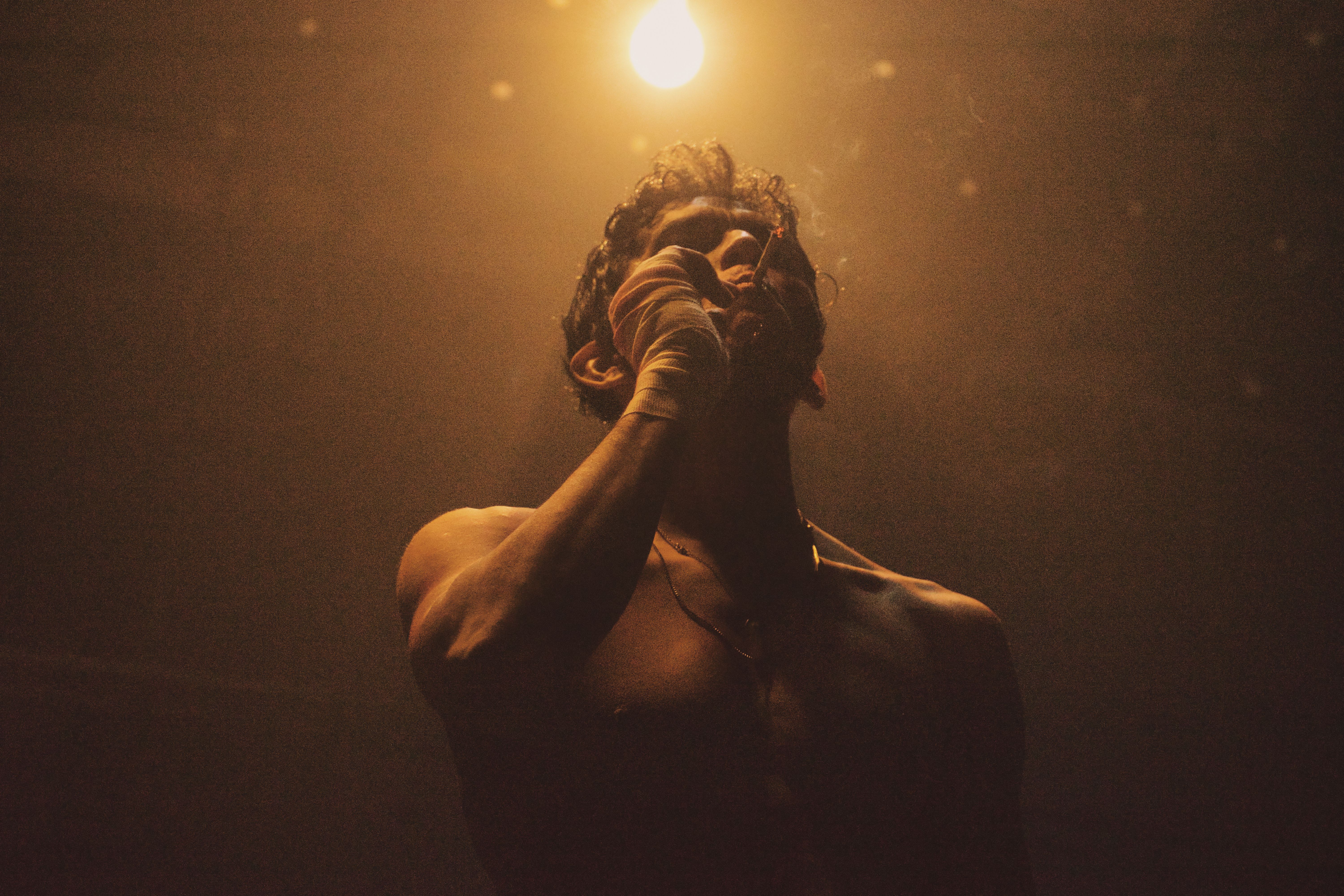 Dramatic Backlit Portrait of Man Under Light · Free Stock Photo