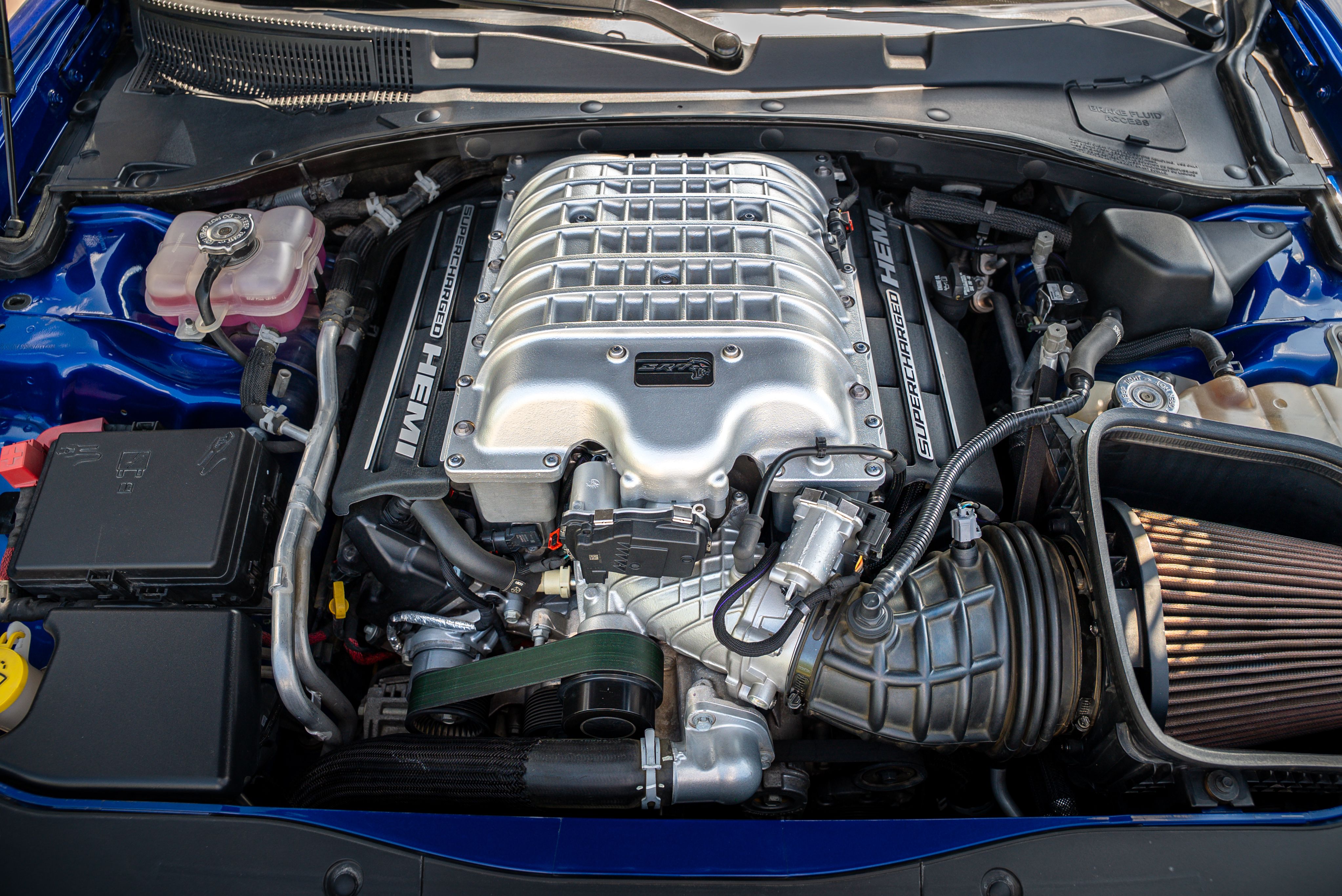 Detailed view of a powerful supercharged HEMI engine in a modern vehicle.