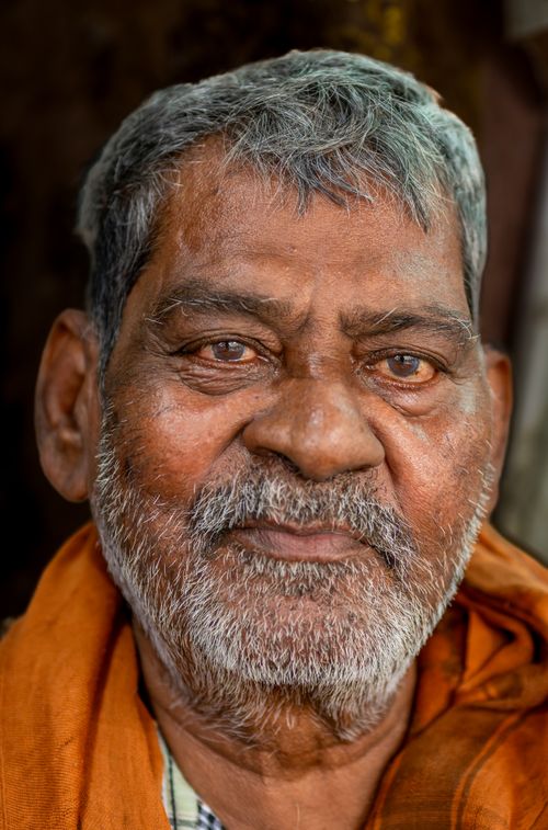 Free Close-up portrait of a senior man with grey hair and a contemplative expression. Stock Photo