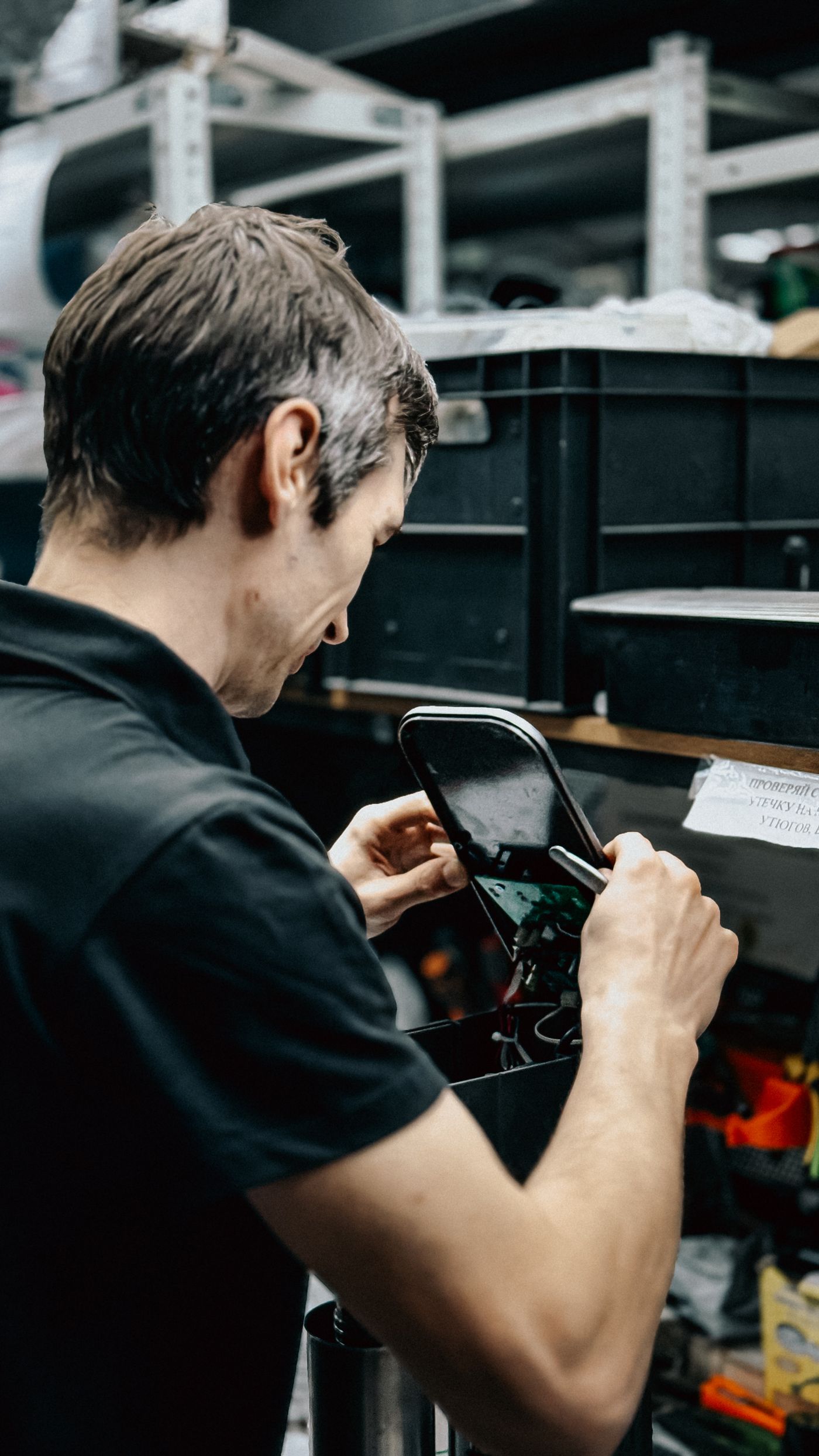 Technician repairing a smartphone in a workshop
