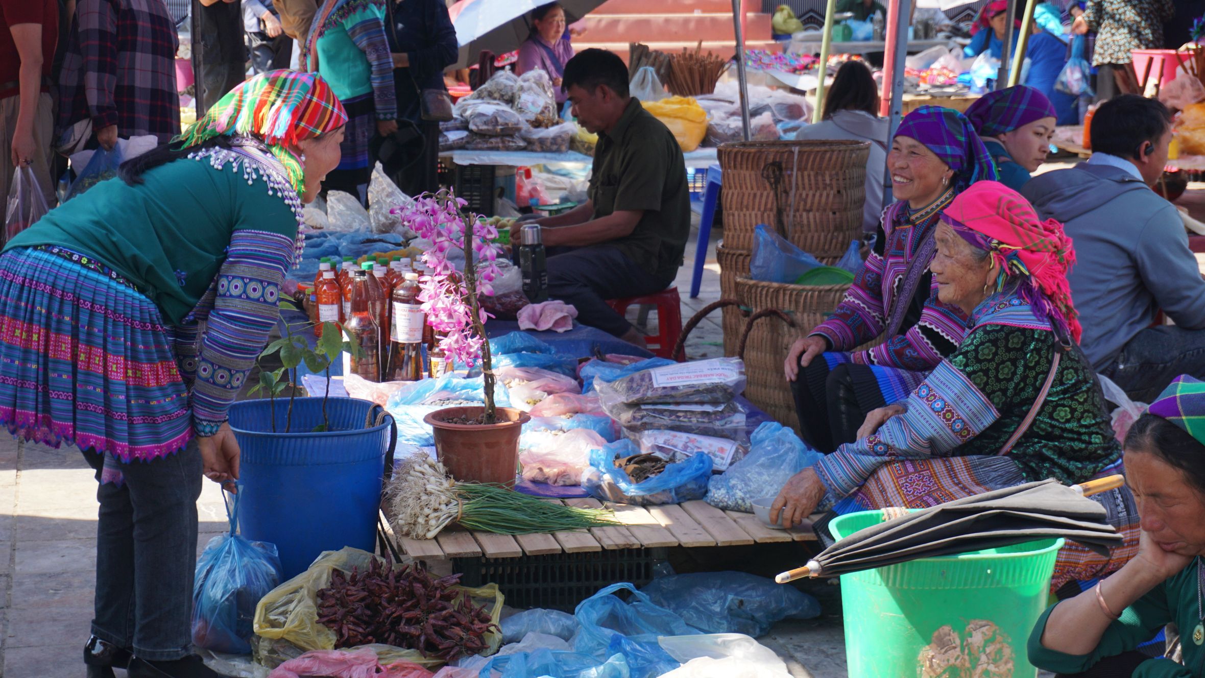 Vibrant scene of locals at Bac Ha Market, showcasing Hmong culture and traditional attire.