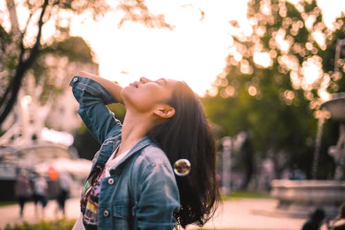 Carefree young woman enjoying life in city park