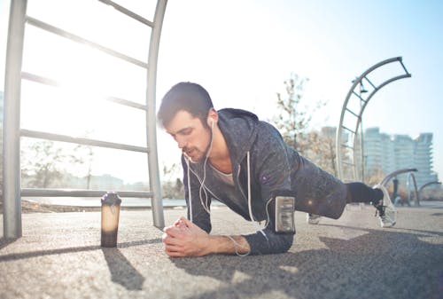 Free Young determined man training alone on street sports ground in sunny day Stock Photo