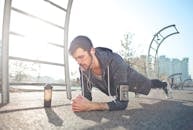 Young determined man training alone on street sports ground in sunny day