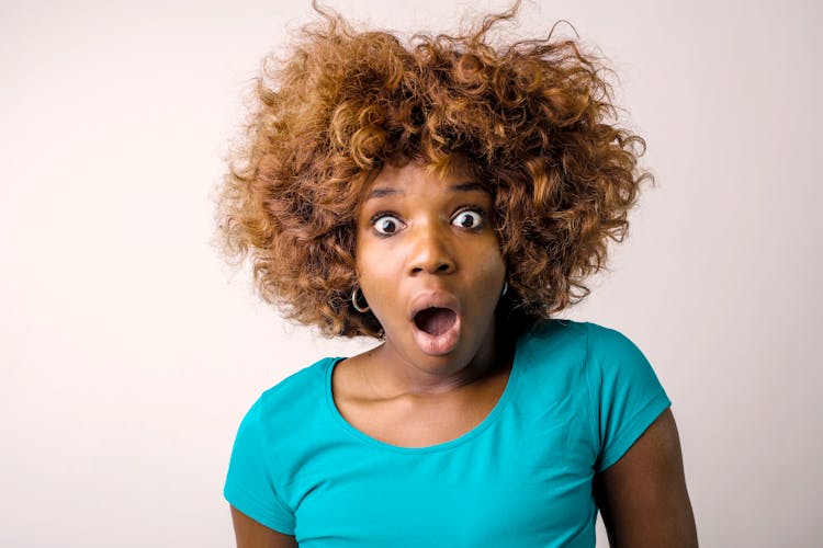 Portrait Photo Of Shocked Woman In Blue T-shirt Standing In Front Of White Background