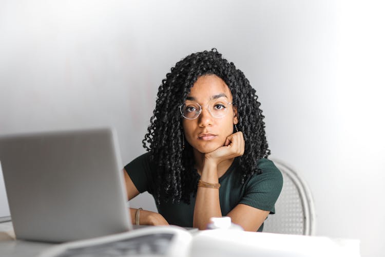 Serious Ethnic Young Woman Using Laptop At Home