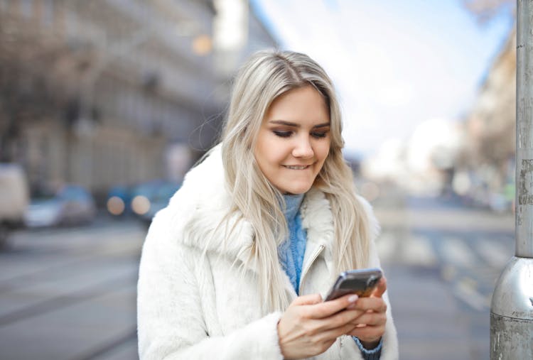 A Girl In A City Using Smart Phone