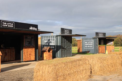 Free Outdoor market stalls named The Little Cow Shed in England, showcasing local produce. Stock Photo