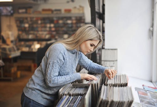 Foco Seletivo Vista Lateral Photo Girl In Grey Sweater Selecionando Discos De Vinil Em Uma Loja De Música