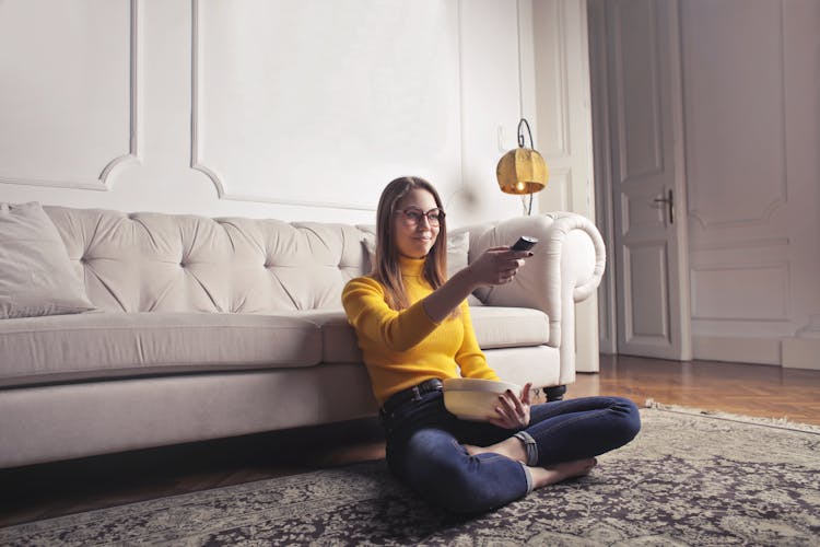 Young Woman Relaxing At Home And Watching Movie