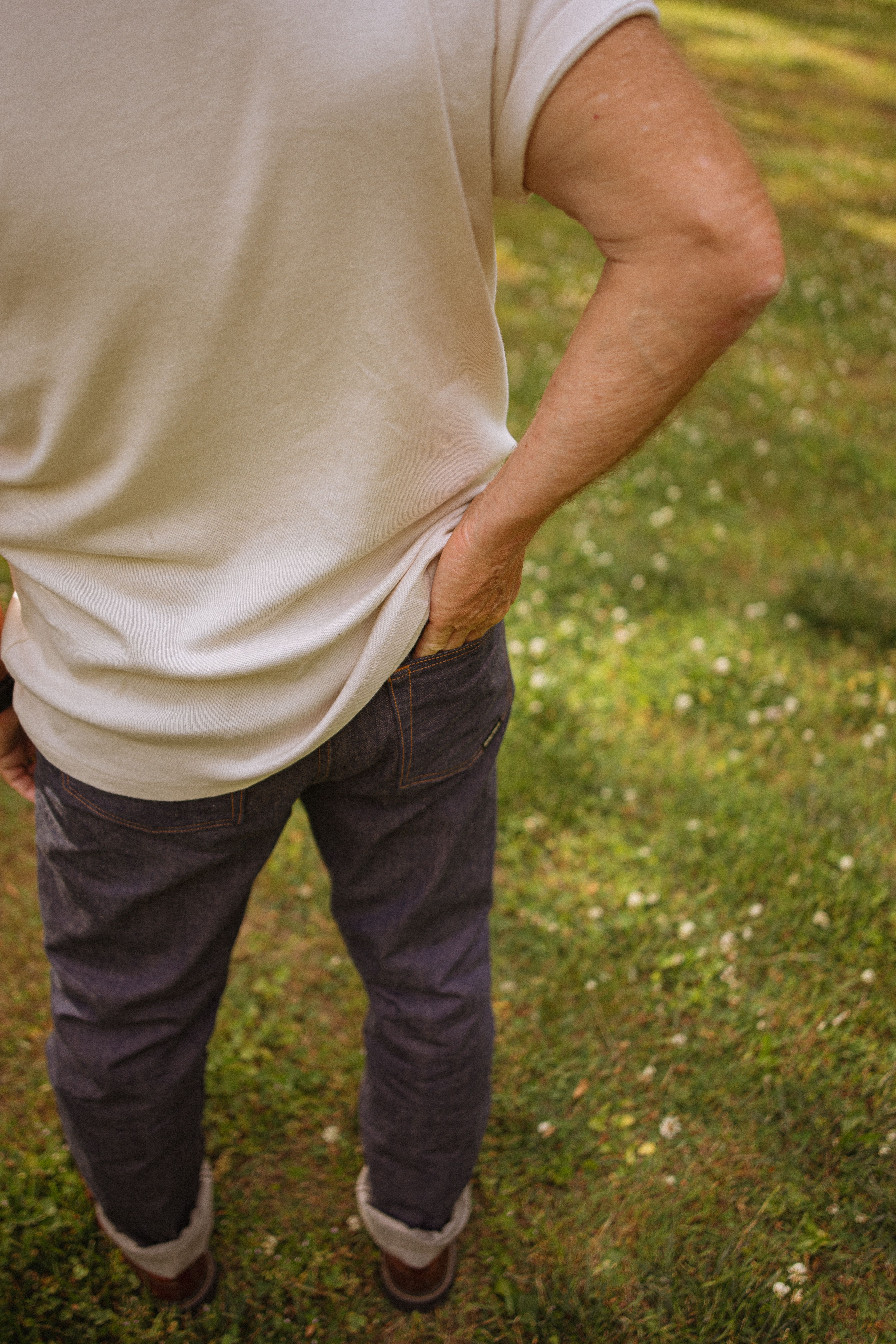 Man in white t-shirt and jeans enjoying a summer day outdoors in North Carolina.