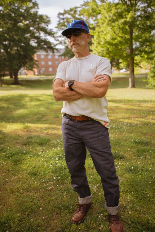 Free Man in casual summer outfit with denim jeans and leather boots in a North Carolina park. Stock Photo