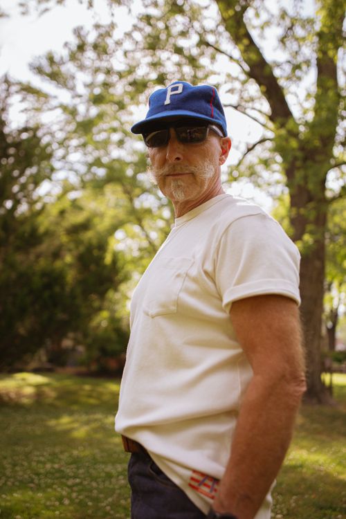 Free A casual portrait of a man in a white t-shirt and baseball cap outdoors in summer, Brevard, NC. Stock Photo