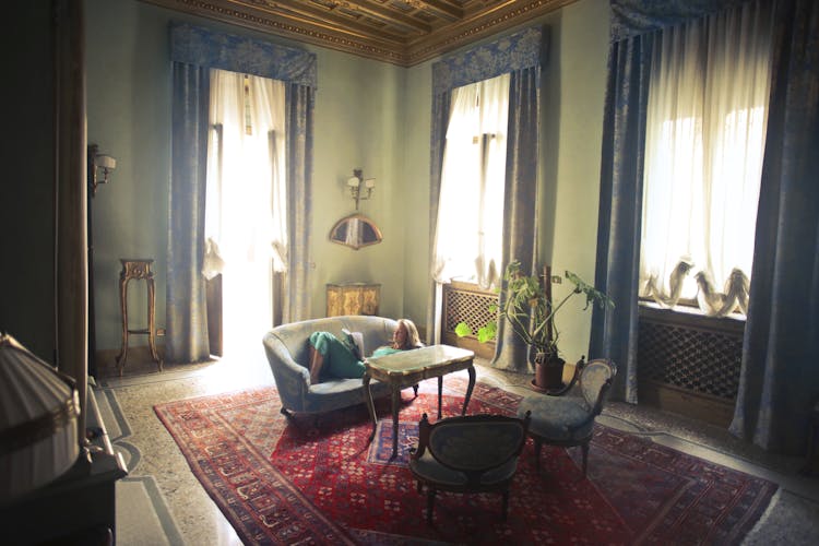 Woman Reading Book In Living Room