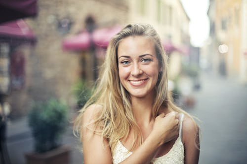 Photo Of A Woman Near Buildings