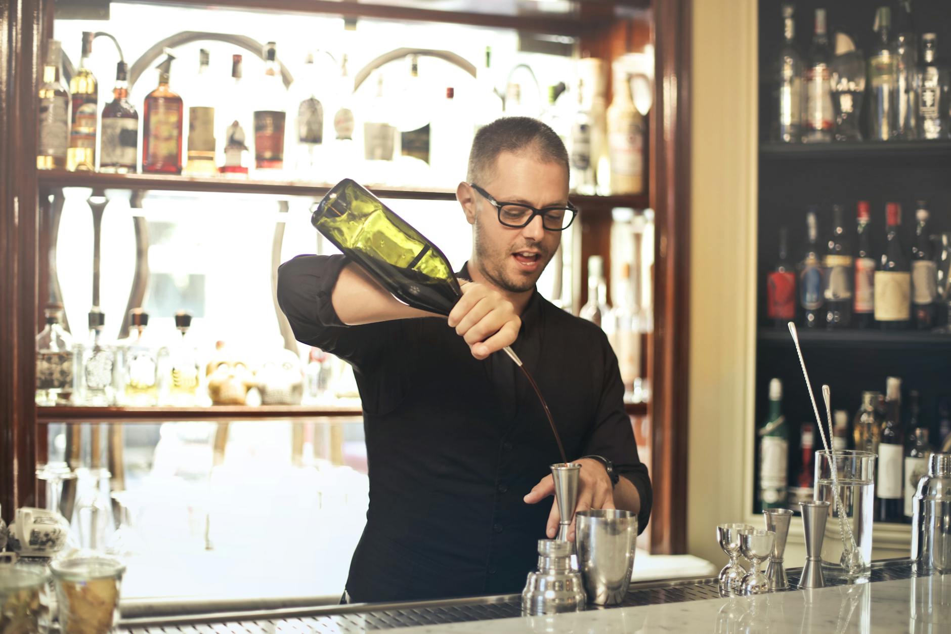 Barman preparing cocktail at counter