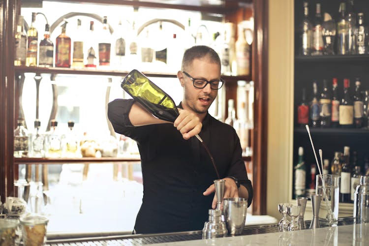 Barman Preparing Cocktail At Counter