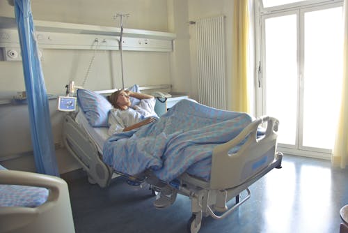 Free Photo of Woman Lying in Hospital Bed Stock Photo