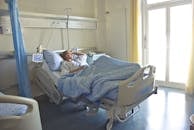 Photo of Woman Lying in Hospital Bed